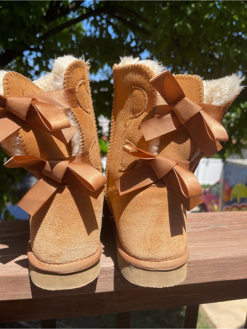 Bailey Bow UGG’s Chestnut Suede Shearling Booties with Ribbon Bows
